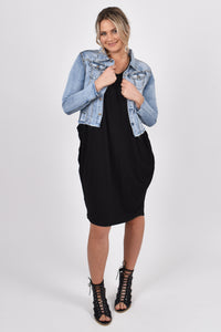 Our Frayed Denim Jacket is perfect for all seasons, made of soft and stretchy denim with a cropped hem for easy layering and all-year wear. The jacket is super stylish with a frayed hem and washed appearance, yet functional with breast and hip pockets, and a split cuff for adjusting the sleeve length. PQ Collection. Unbuttoned front view